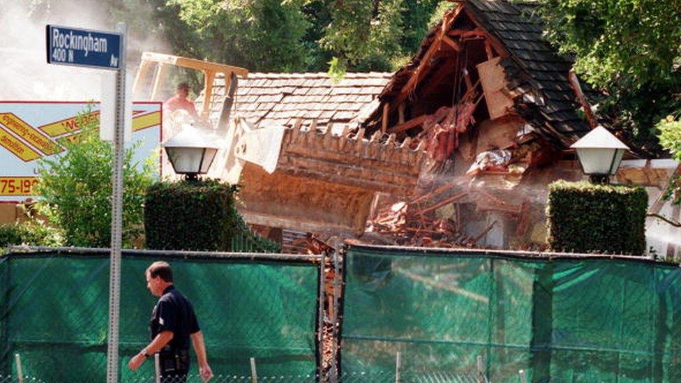 A bulldozer tears down OJ's house in July 1998