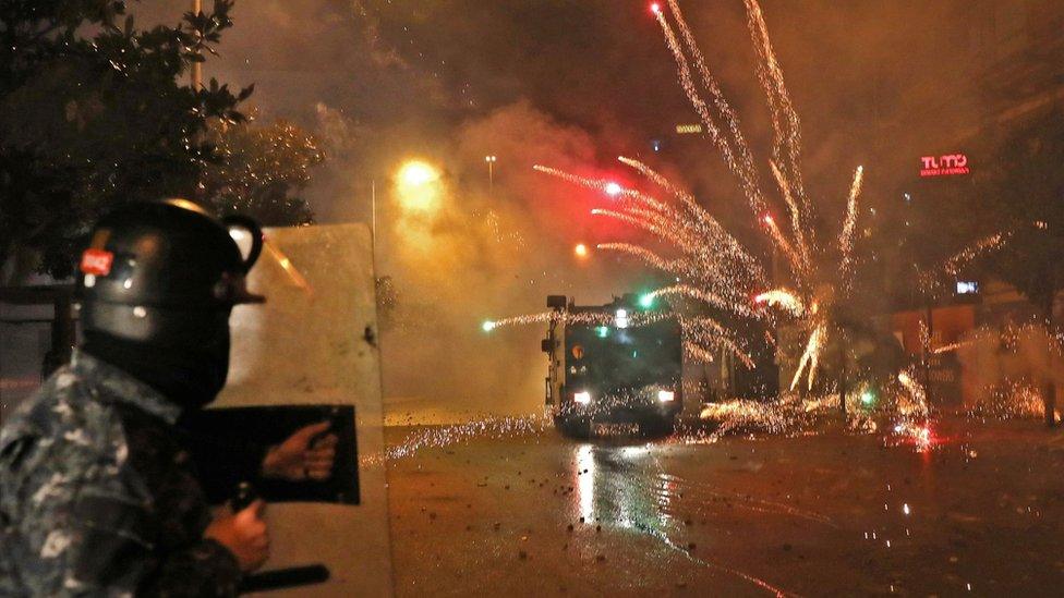 Young Shia men throw fireworks at security forces in Beirut, Lebanon (17 December 2019)