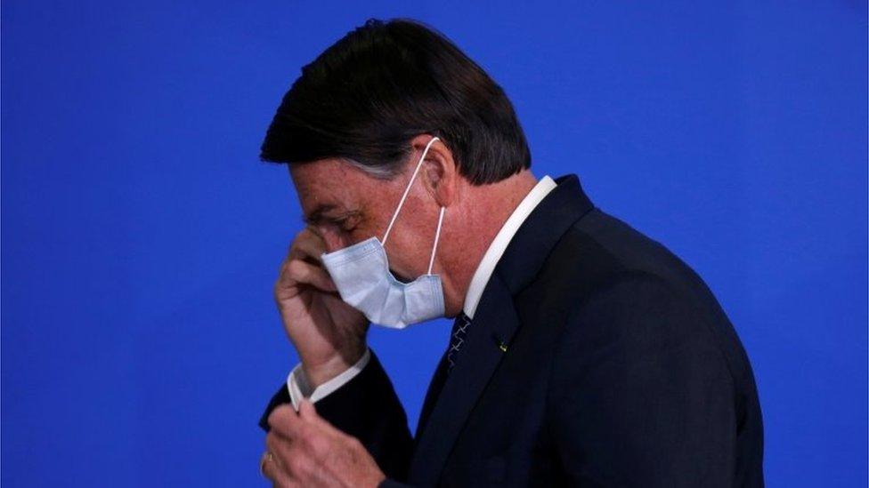 Side-view of President Bolsonaro wearing a mask