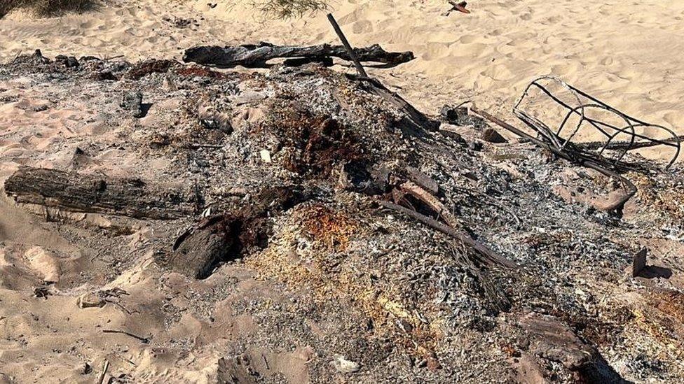 The remains of the bench following the suspected arson attack