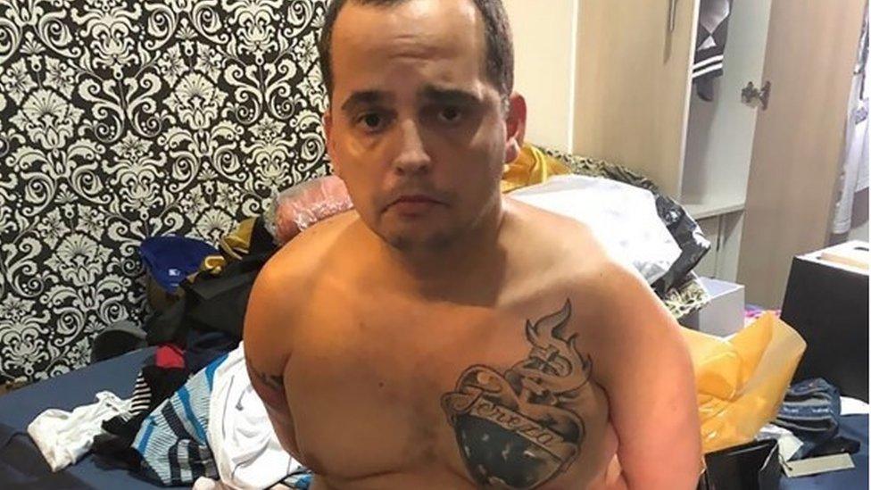 Police picture of Stephan de Souza Vieira, aka BH, a drug dealer that escaped from Aparecida de Goiania Prison Complex in November 2017, sitting on a bed after his re-arrest in Cabo Frio municipality, Rio de Janeiro State, Brazil, on 7 January, 2018.