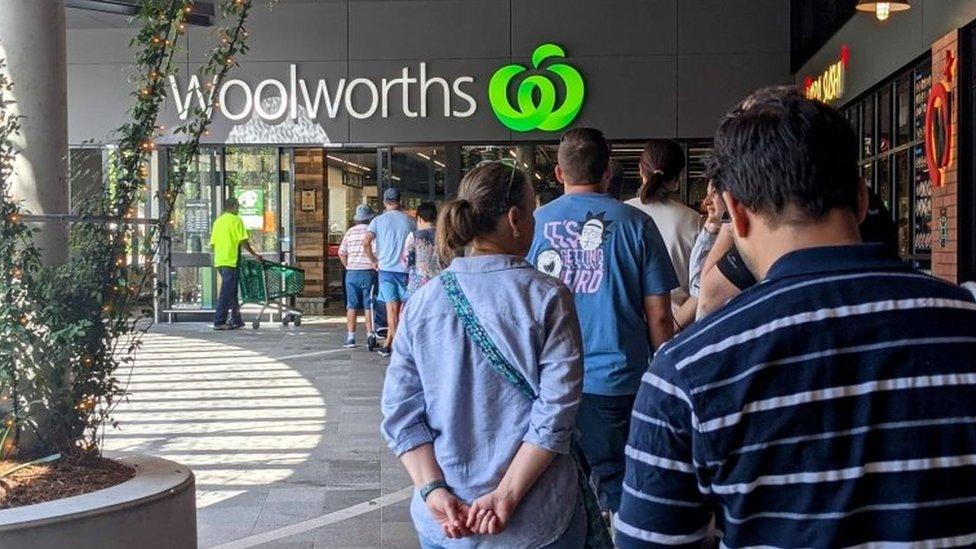 Shoppers queue in Brisbane on Monday