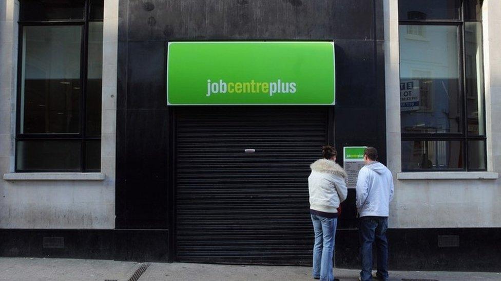 Two people stood outside a Job Centre