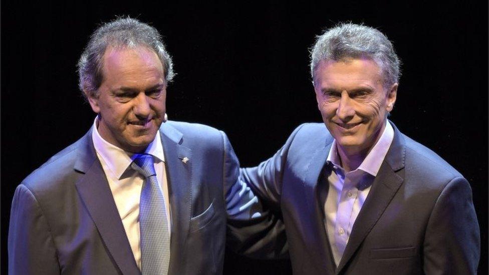 Daniel Scioli (left) and Mauricio Macri embrace before a debate in Buenos Aires on 15 November, 2015, ahead of next November 22 run-off election.