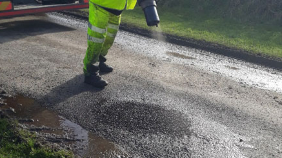 Pothole being fixed