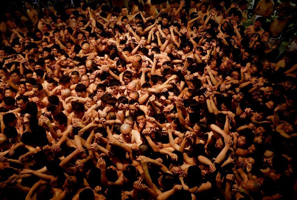 Men dressed in loincloths prepare to snatch a wooden stick called "shingi" tossed by the priest during a naked festival at Saidaiji Temple in Okayama, Okayama Prefecture Japan, 15 February 2020.