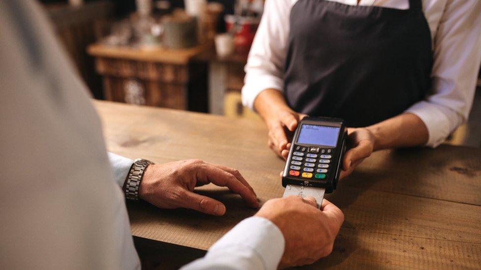 Man using credit card at shop