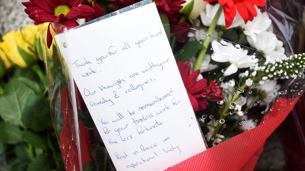 A bunch of flowers with a written messages which says: "Thank you for all your hard work. Our thoughts are with your family and colleagues. You will be remembered for your tireless work for the less fortunate. Rest in peace. An inspirational lady."