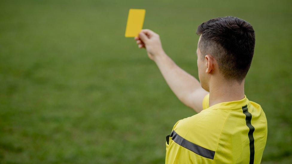 Yellow card used at a football game