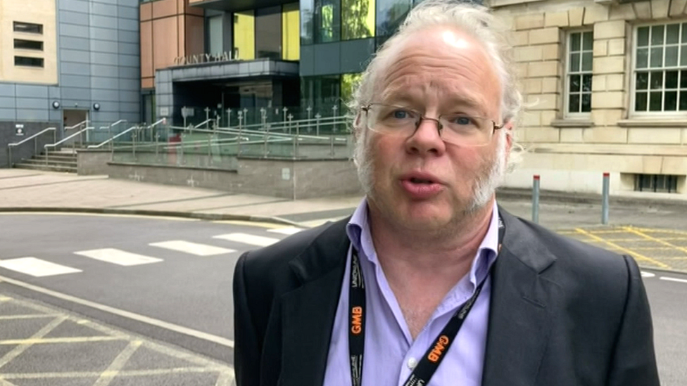 A man from a trade union stood outside the county hall council building