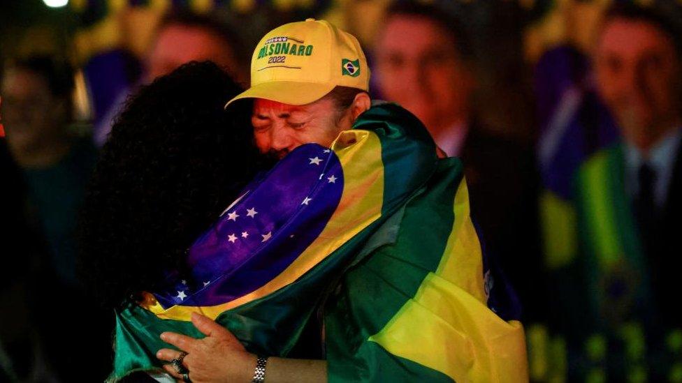 Supporters of Brazilian President Jair Bolsonaro react after polls were closed in Brazil's presidential election, in Brasilia, Brazil October 2, 2022.