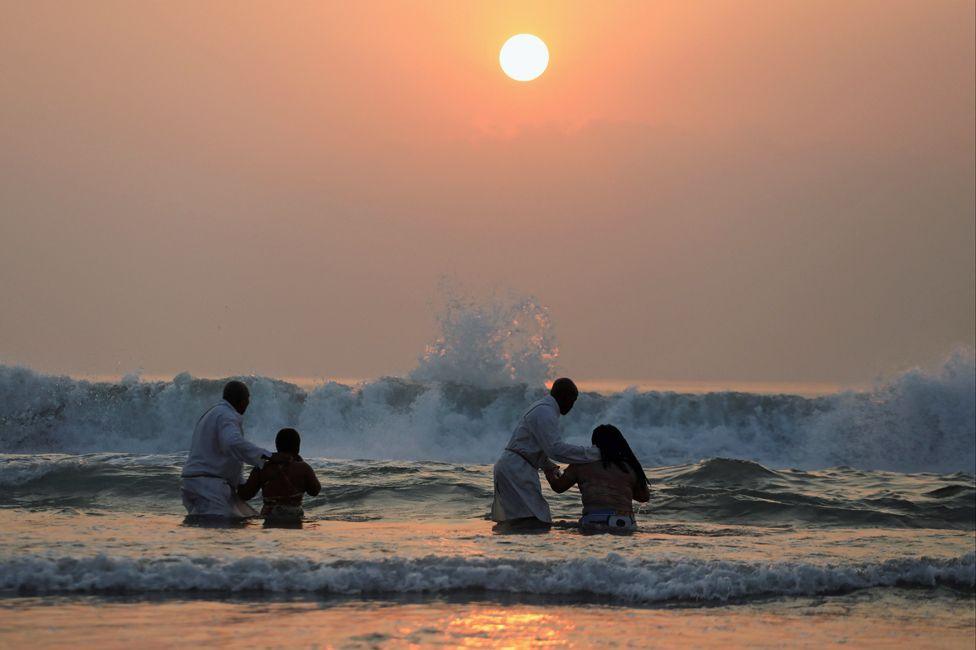 Members of Zion Christian Church perform baptisms in the seas at North Beach in Durban, South Africa – Sunday 2 June 2024