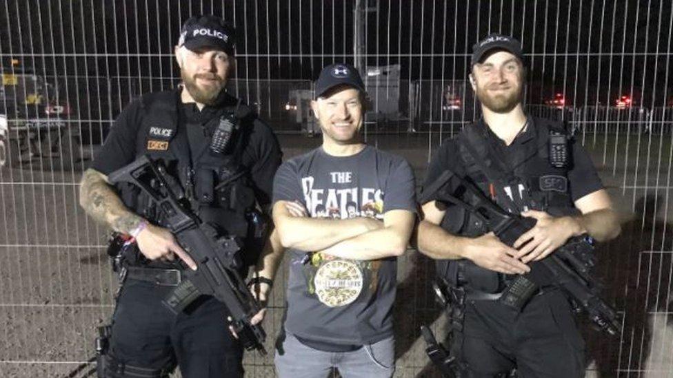 Man with two armed officers