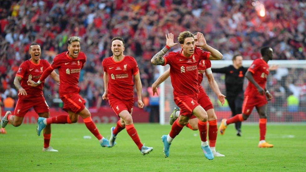 Liverpool's Kostas Tsimikas celebrates with his team-mates after scoring the winning penalty