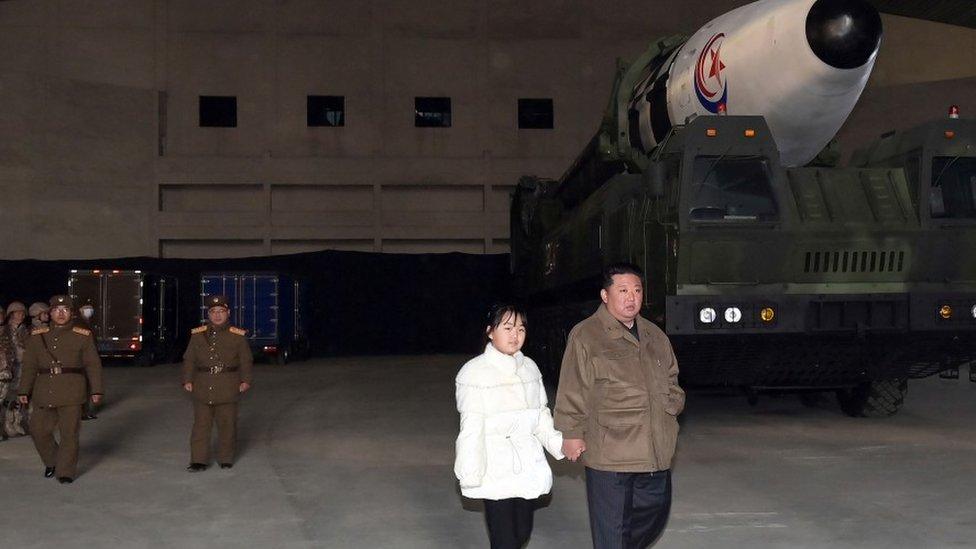 Ju Ae and her father at a weapons factory