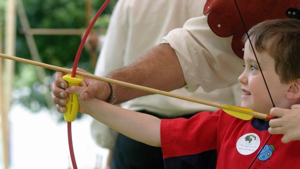 Young boy with a bow and arrow