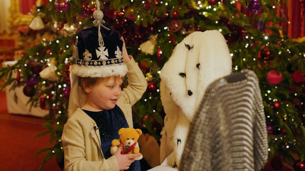 Olivia Taylor from Sidcup wears a replica of the Queen Mary crown after taking tea with Queen Camilla at Windsor Castle