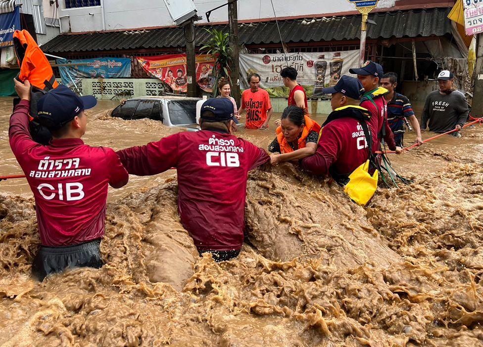 A handout photo made available by Central Investigation Bureau (CIB) shows CIB personnel helping flood victims during flooding due to heavy rain in urban areas of Chiang Rai Province, northern of Thailand, 12 September 2024.