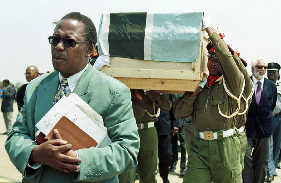 Religious leaders accompany the coffin, draped in the flag and carried by Botswana soldiers, on 4 October 2000