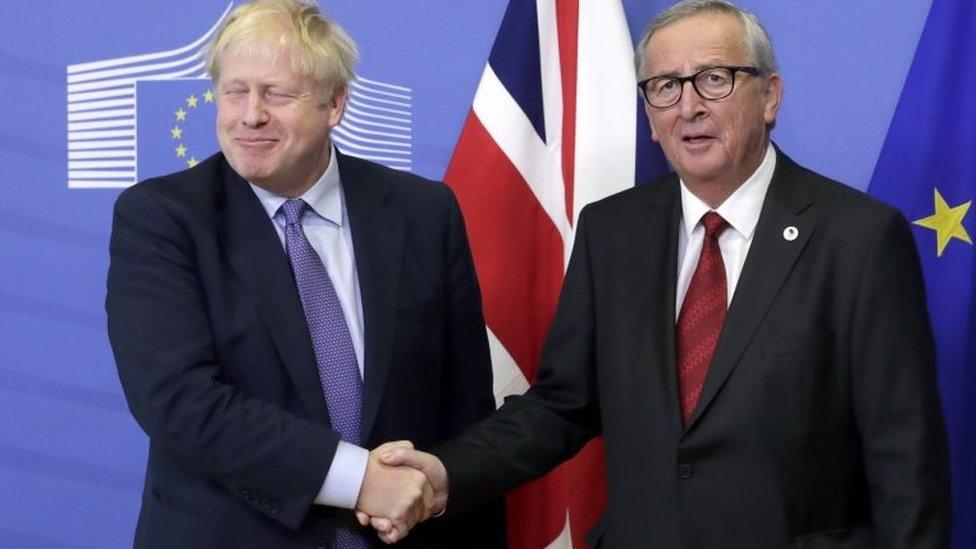 Boris Johnson and Jean-Claude Juncker shake hands after agreeing the Brexit deal in October