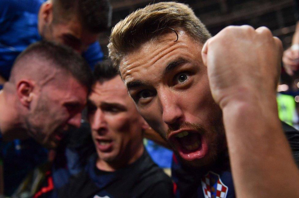 Croatia's defender Josip Pivaric (R) celebrates with teammates after Croatia's forward Mario Mandzukic (C) scored their second goal during the Russia 2018 World Cup semi-final football match between Croatia and England at the Luzhniki Stadium in Moscow on 11 July 2018