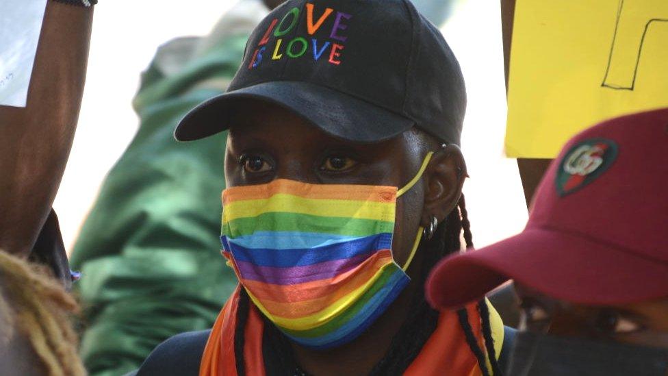 Person wearing a rainbow face mask