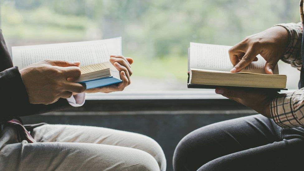 Two people reading books