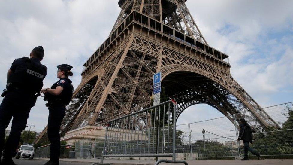 French police patrol near the Eiffel tower as part of security measures in Paris, France, 13 July 2017.