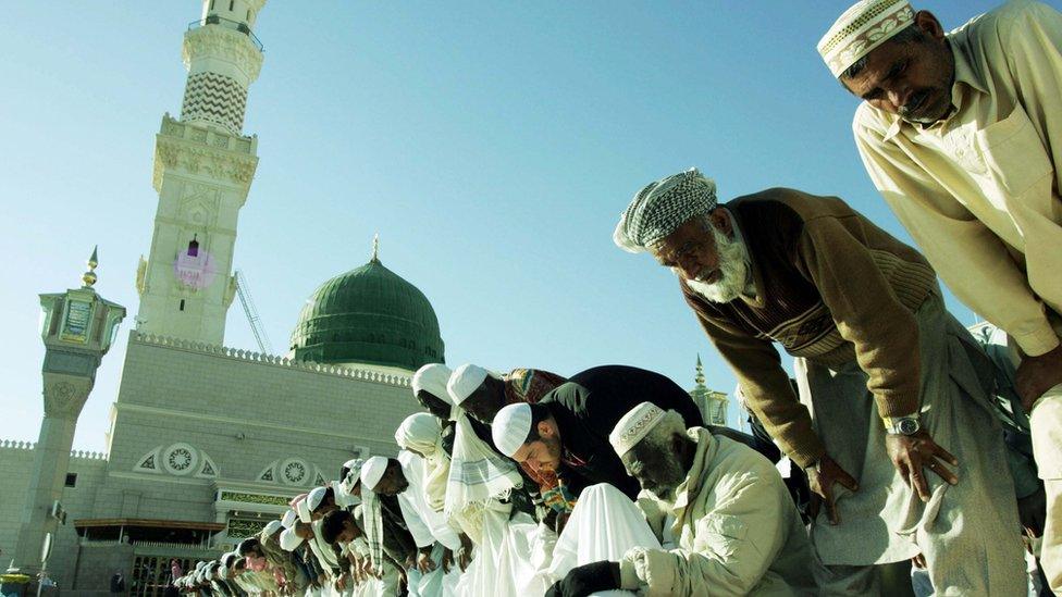 Pilgrims pray in the courtyard of the Prophet Mohammed Mosque in the holy Saudi city of Medina