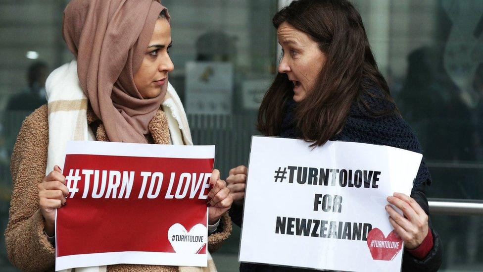 Members of the Turn to Love campaign hold placards outside New Zealand High Commission in Haymarket, London