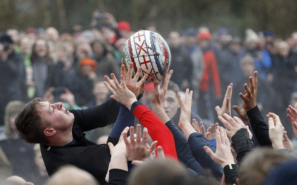 Players compete for the ball during the annual Shrovetide football match in Ashbourne, 28 February 2017