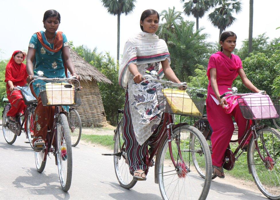 Girls cycle home from high school on bicycles provided by the Bihar state government