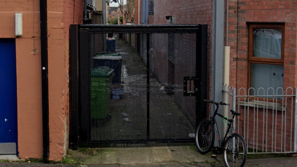 A gate on an alleyway between houses in south Belfast