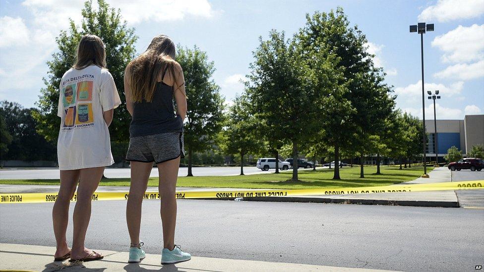 Two women stand in silence in front of the Grand Theatre following Thursday's deadly shooting in Lafayette - 24 July 2015