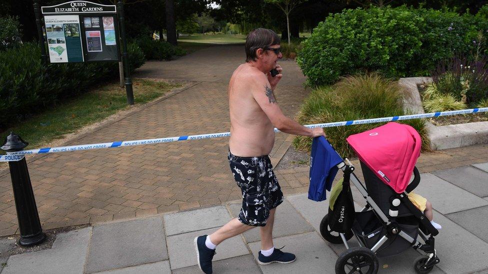 Man walks past cordon in city