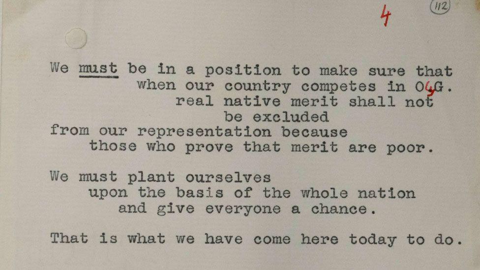 A sepia-toned close up of a paper upon which a speech by Winston Churchill was written, including handwritten correction in red