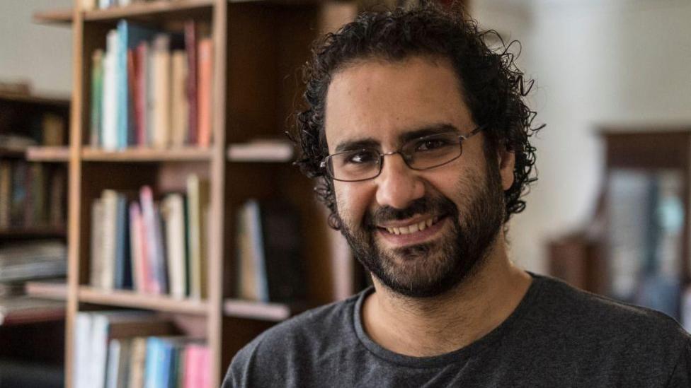 Alaa Abdel Fattah is smiling in a picture taken before he was jailed.