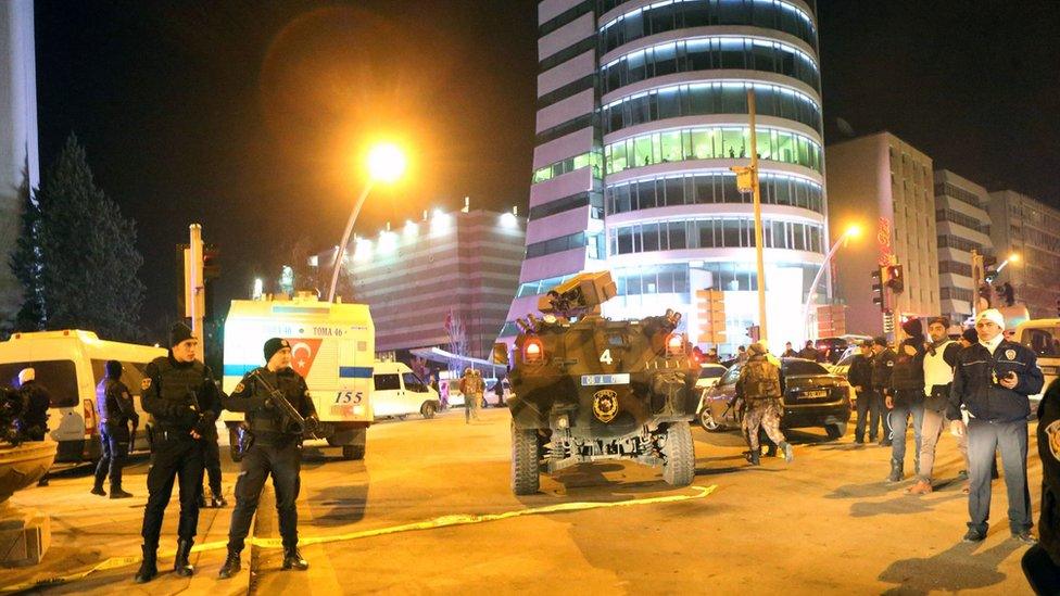 Turkish soldiers and policemen stand guard outside the Cagdas Sanatlar Merkezi, a major art exhibition hall, where Andrey Karlov, the Russian ambassador to Ankara, has been shot dead