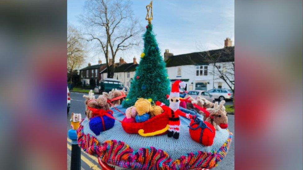 A Christmas scene with a Santa Claus and tree