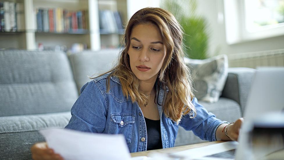 Woman looking at bills