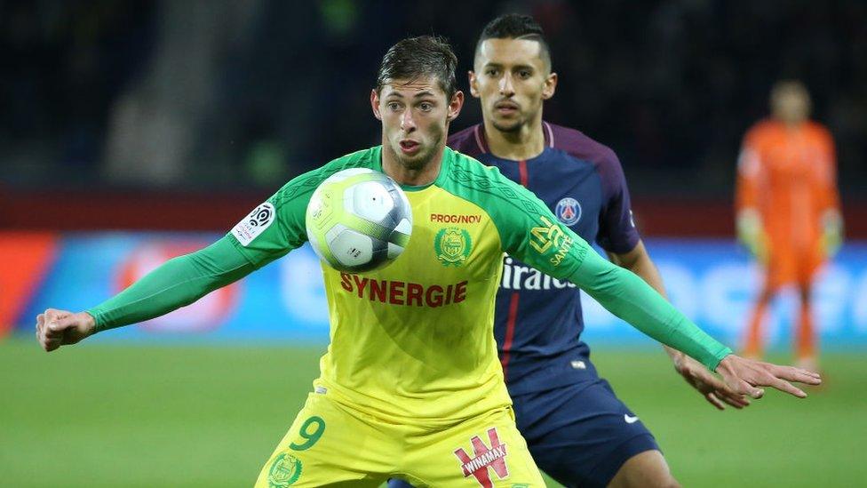 Emiliano Sala holds off PSG defender Marquinhos