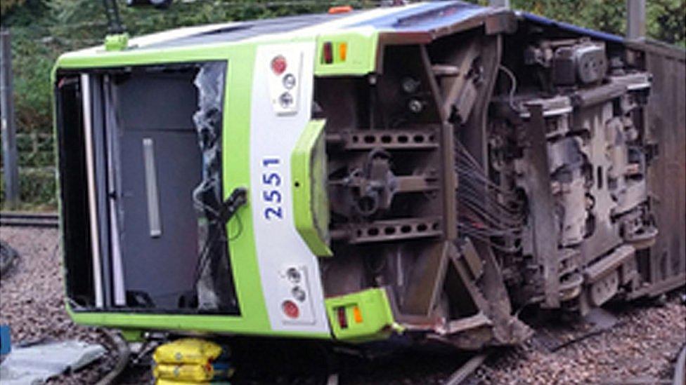 The tram on its side