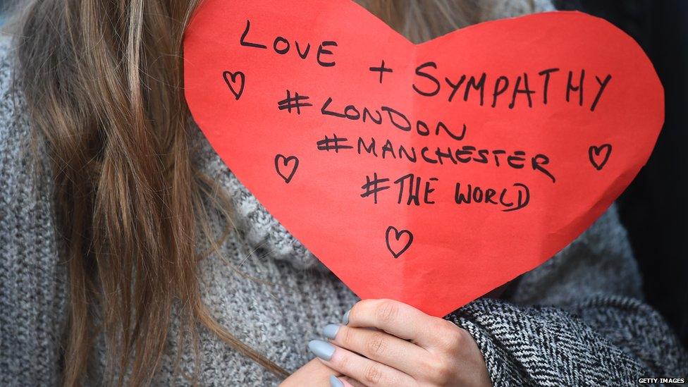 Woman holds Manchester/London heart