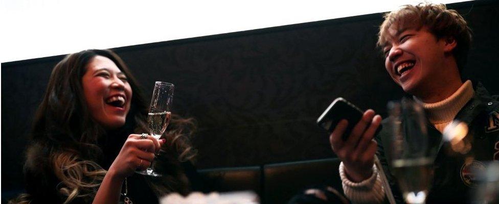 businesswoman Aki Nitta (L) drinks champagne