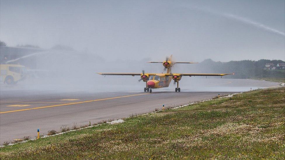 G-Joey is met by a water salute at Guernsey Airport after completing its last flight