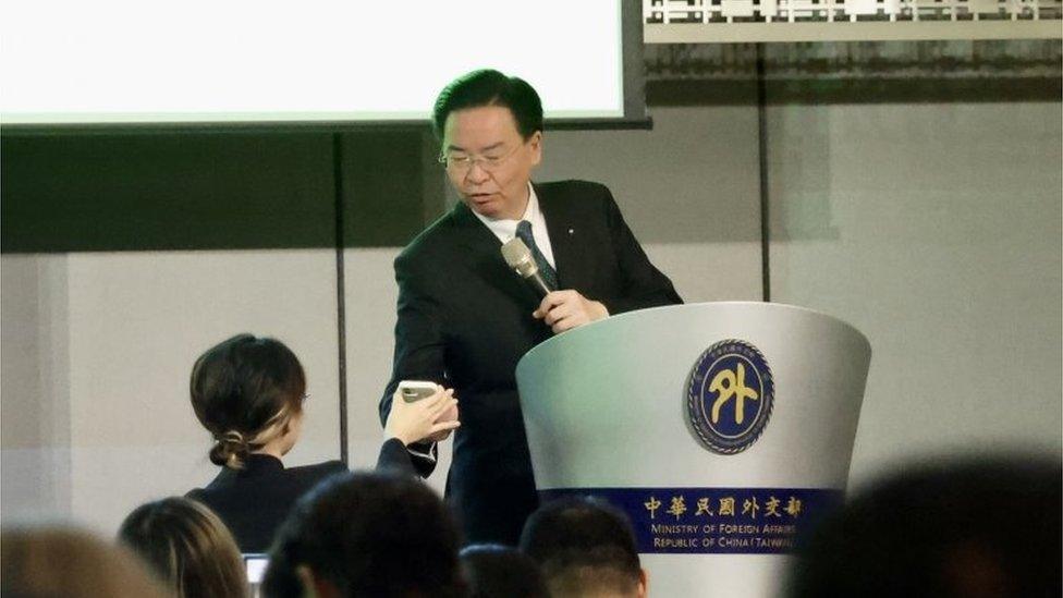 Taiwan"s foreign minister Joseph Wu checks the lost in translation emergency alert pop-up on a mobile phone during his press conference in Taipei, Taiwan, 09 January 2024.