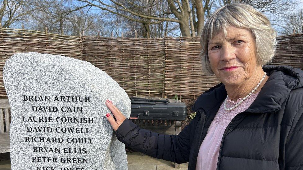 Di Struthers standing beside the memorial stone