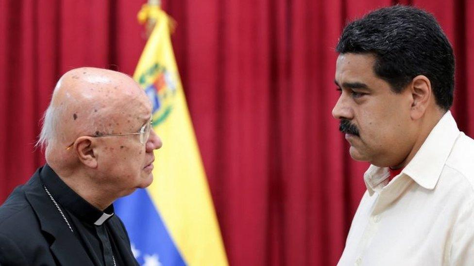 Handout picture released by the Venezuelan Presidency showing Venezuelan President Nicolas Maduro listening to Monsignor Claudio Maria Celli, on October 31, 2016