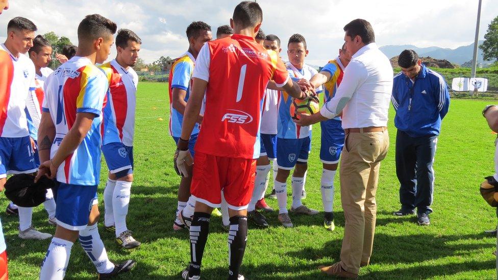 The players form a circle to cheer themselves up before the game