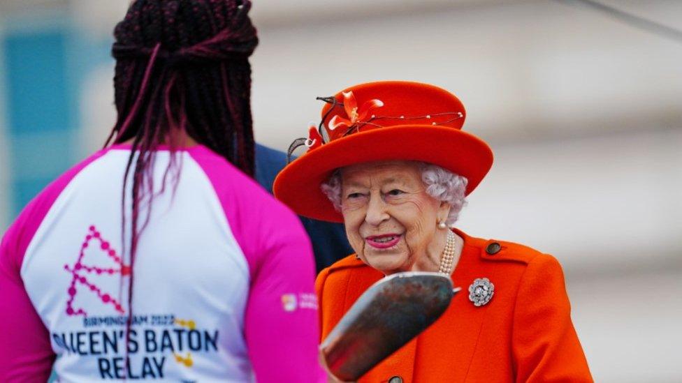 Double Paralympic gold medallist Kadeena Cox being handed the baton by the Queen